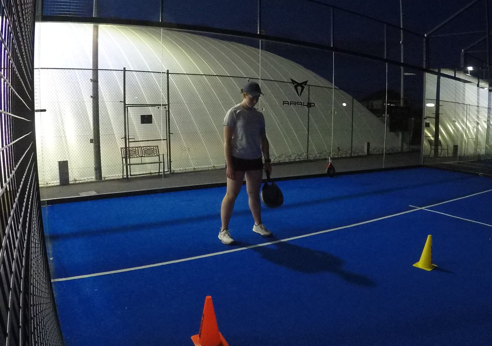 Anna Zuka training on the padel court at night