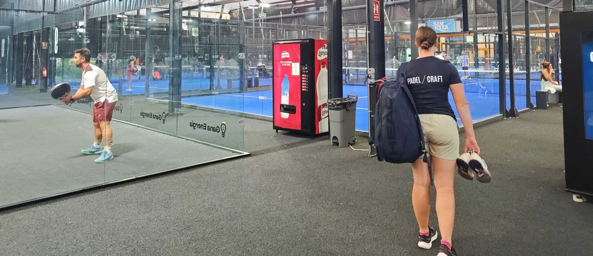 Anna Zuka walking through BamVolea SportCity in Valencia with her racket bag