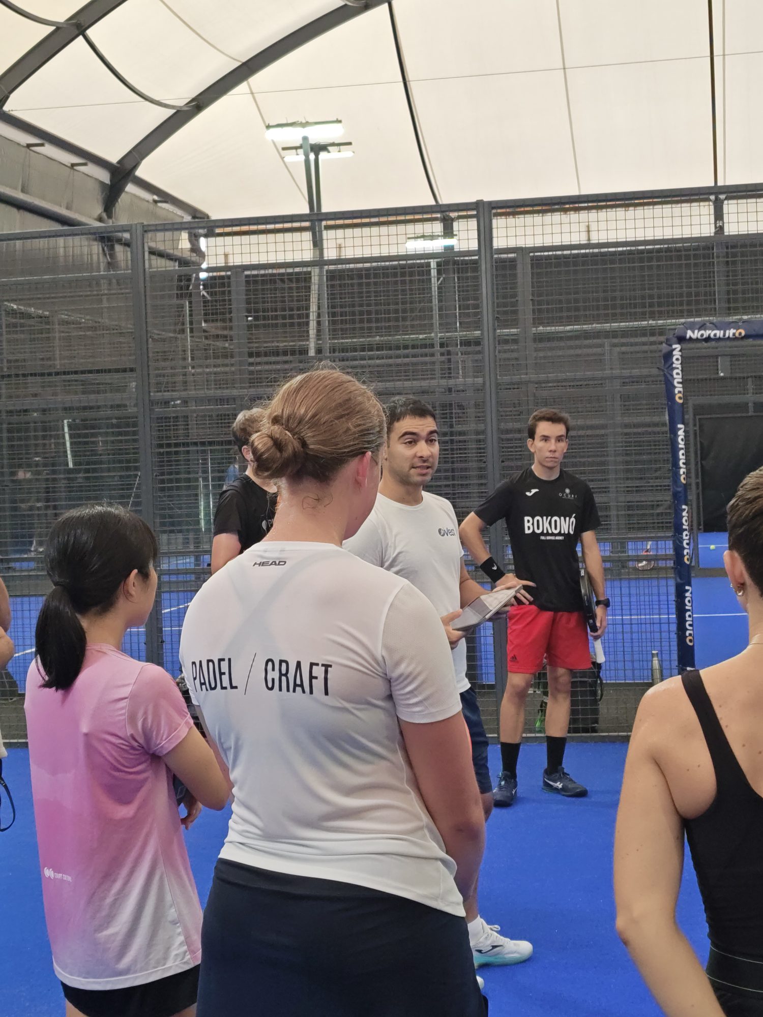 Anna Zuka in a Padel-Craft shirt during a coach briefing at VEST Padel Academy