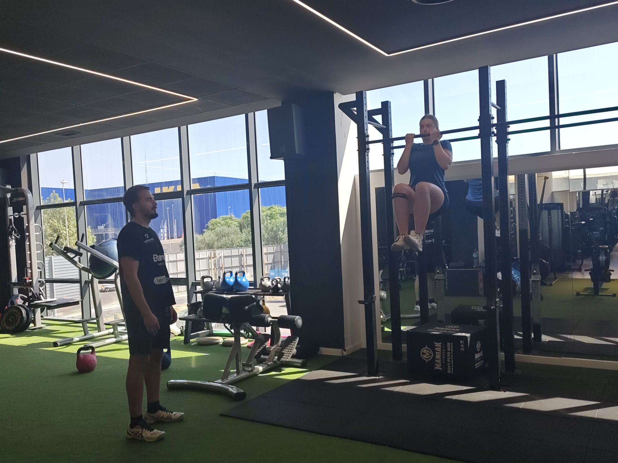 Anna Zuka performing pull-ups in the gym at BamVolea SportCity